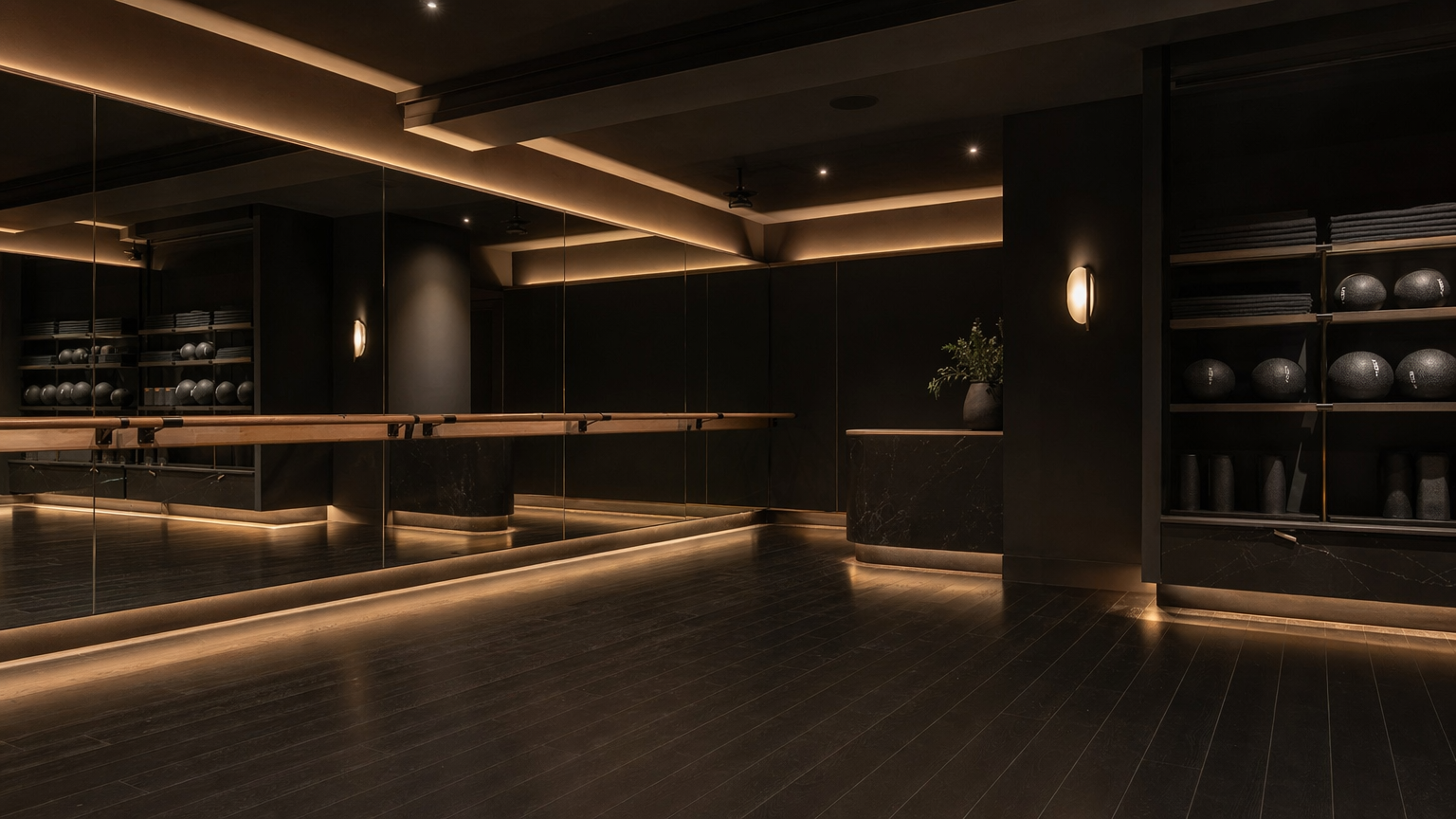 Barre studio with mirrored walls and dark hardwood